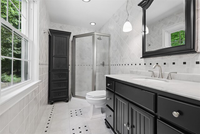 23 Entrance Way, Purdys, NY 10578 - bathroom with tile walls, a shower stall, tile patterned flooring, vanity, and toilet