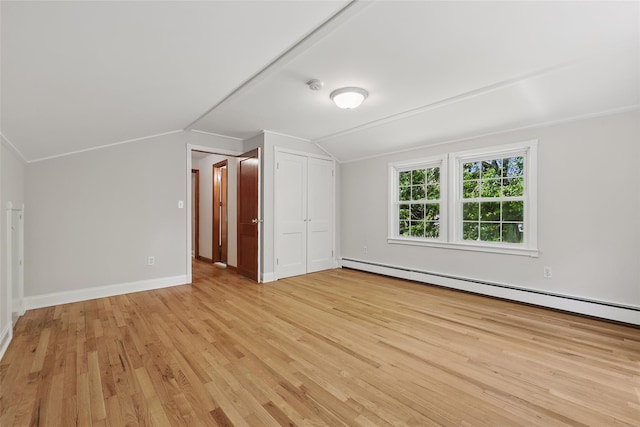 23 Entrance Way, Purdys, NY 10578 - unfurnished bedroom featuring a baseboard heating unit, light wood-style floors, vaulted ceiling, baseboards, and a closet