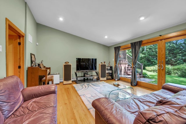 living area featuring lofted ceiling, wood finished floors, recessed lighting, and french doors
