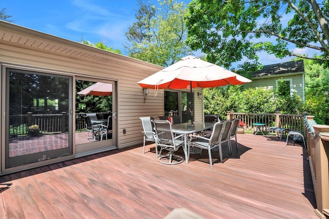wooden terrace featuring outdoor dining space