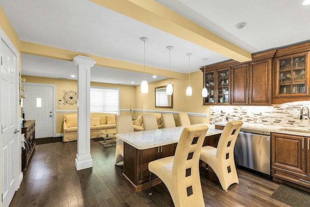 kitchen with ornate columns, dark wood finished floors, hanging light fixtures, decorative backsplash, and dishwasher