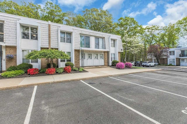 view of property featuring uncovered parking