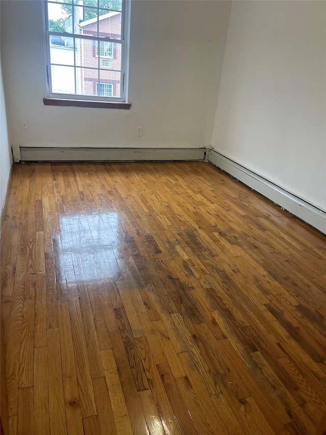 10615 155th St, Jamaica, NY 11433 - unfurnished room featuring hardwood / wood-style floors and a baseboard radiator
