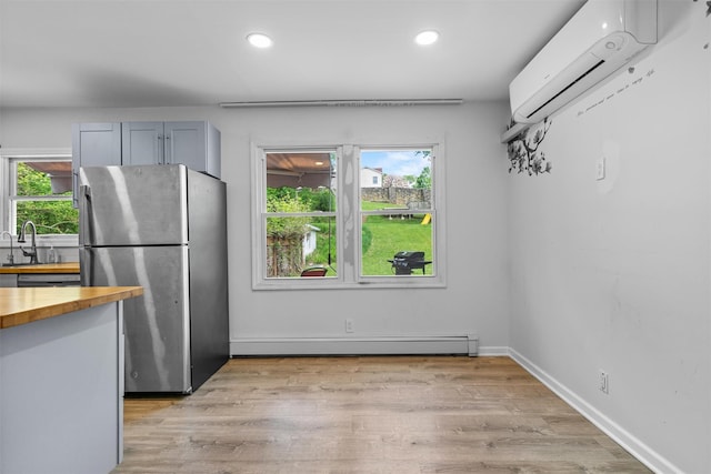15 Scanlon Ave, Florida, NY 10921 - kitchen featuring freestanding refrigerator, butcher block countertops, a baseboard heating unit, an AC wall unit, and plenty of natural light