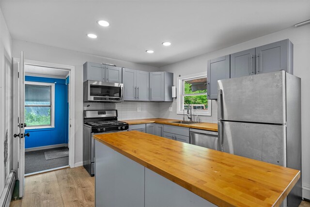 15 Scanlon Ave, Florida, NY 10921 - kitchen with stainless steel appliances, butcher block countertops, a sink, gray cabinetry, and a baseboard heating unit