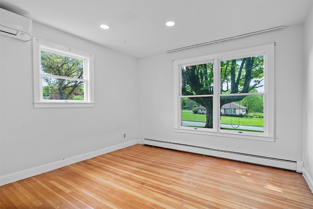 15 Scanlon Ave, Florida, NY 10921 - empty room featuring a baseboard heating unit, a wall mounted AC, recessed lighting, baseboards, and light wood-type flooring