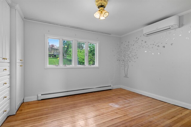 15 Scanlon Ave, Florida, NY 10921 - unfurnished room with a baseboard heating unit, a wall unit AC, light wood-style floors, ornamental molding, and baseboards