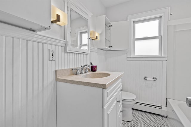 15 Scanlon Ave, Florida, NY 10921 - full bath with a baseboard heating unit, a wainscoted wall, toilet, vanity, and a tub to relax in