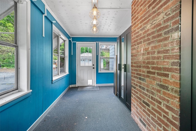 15 Scanlon Ave, Florida, NY 10921 - doorway to outside featuring baseboards, brick wall, and carpet