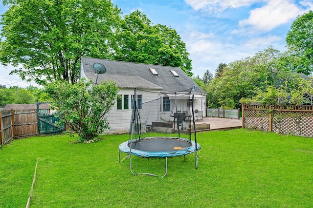 15 Scanlon Ave, Florida, NY 10921 - rear view of house with a trampoline, a patio, a shingled roof, and a gate