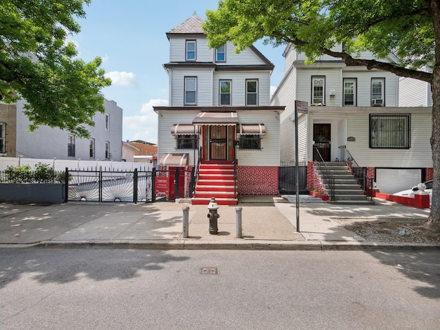 view of front of property with fence and a gate