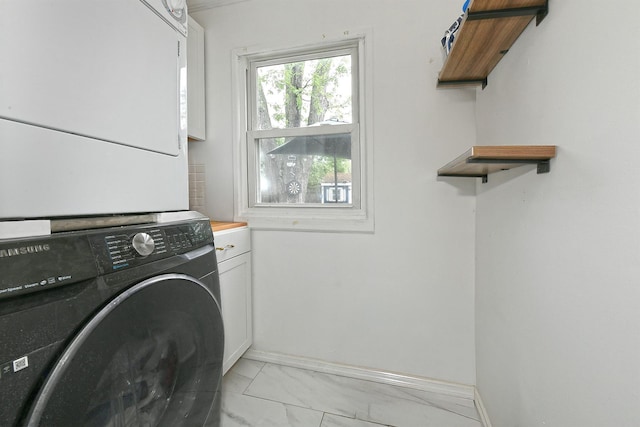 133 Spring Ln, Levittown, NY 11756 - washroom with stacked washing machine and dryer, cabinet space, light marble finish floors, and baseboards
