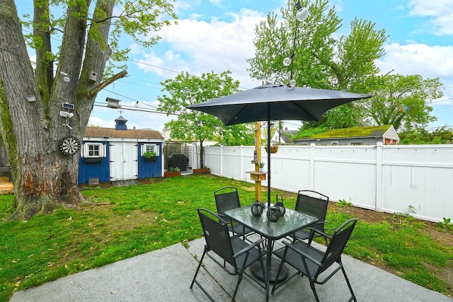133 Spring Ln, Levittown, NY 11756 - view of patio / terrace with outdoor dining space, a storage shed, and an outbuilding