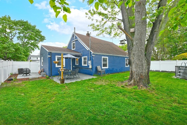 133 Spring Ln, Levittown, NY 11756 - back of property featuring a chimney, a patio, and roof with shingles
