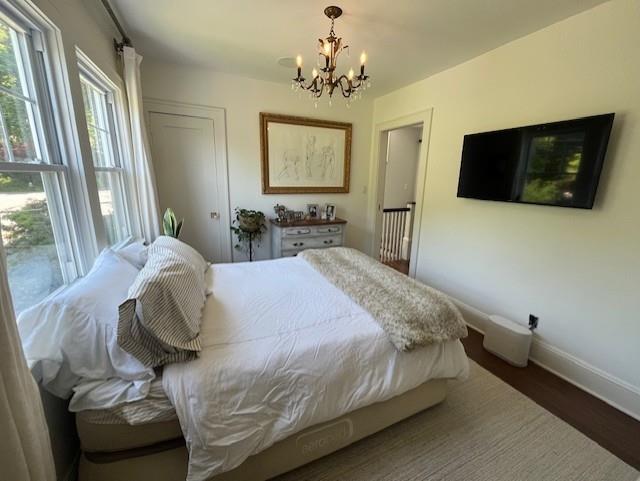 5 Donald Dr, Hastings-On-Hudson, NY 10706 - bedroom featuring a chandelier, baseboards, and wood finished floors