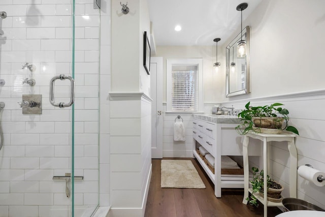 5 Donald Dr, Hastings-On-Hudson, NY 10706 - bathroom with a shower stall, wood finished floors, vanity, wainscoting, and tile walls