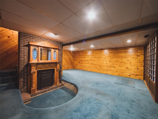 61 Reinhardt Rd, Middletown, NY 10940 - unfurnished living room with wood walls, carpet flooring, a fireplace, and a drop ceiling