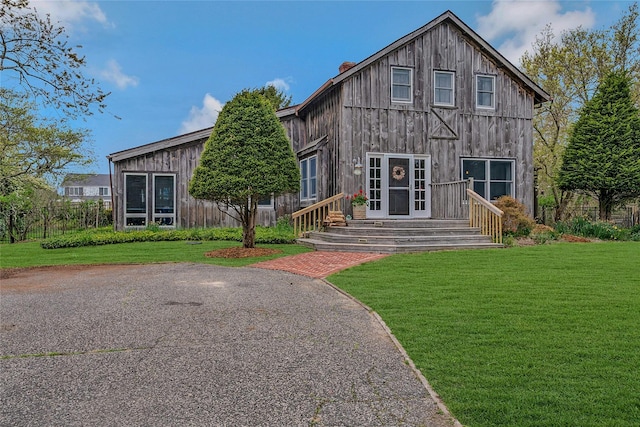 5A/5B Jessup Ln, Quogue, NY 11959 - rear view of house featuring a chimney