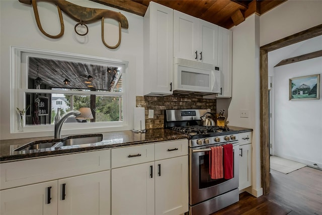5A/5B Jessup Ln, Quogue, NY 11959 - kitchen with stainless steel gas stove, white microwave, a sink, dark wood-style floors, and dark stone countertops