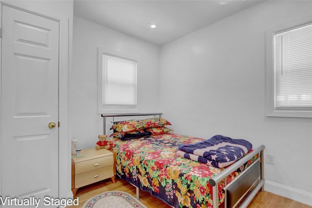 11511 173rd St, Addisleigh Park, NY 11434 - bedroom with light wood-type flooring, baseboards, and multiple windows