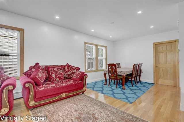 11511 173rd St, Addisleigh Park, NY 11434 - living room with wood finished floors, healthy amount of natural light, baseboards, recessed lighting, and baseboard heating