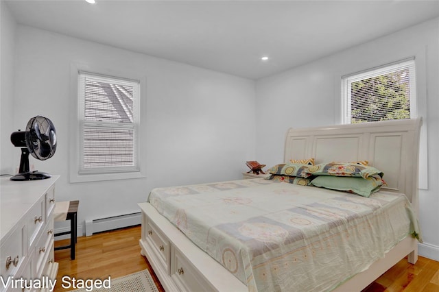 11511 173rd St, Addisleigh Park, NY 11434 - bedroom with baseboard heating, light wood-type flooring, and recessed lighting