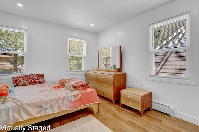 11511 173rd St, Addisleigh Park, NY 11434 - bedroom featuring light wood-type flooring, a baseboard heating unit, multiple windows, and recessed lighting