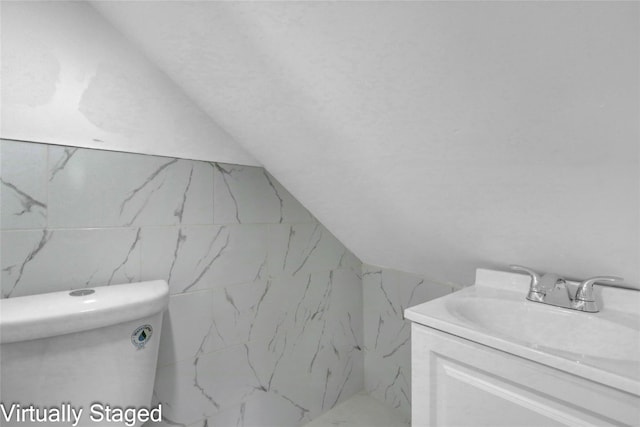 11511 173rd St, Addisleigh Park, NY 11434 - bathroom featuring vanity, toilet, marble finish flooring, and lofted ceiling