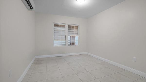 504 Van Nest, Bronx, NY 10460 - spare room with a wall mounted air conditioner and baseboards