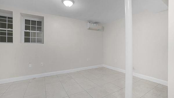 504 Van Nest, Bronx, NY 10460 - finished below grade area featuring a wall mounted air conditioner, baseboards, and tile patterned flooring