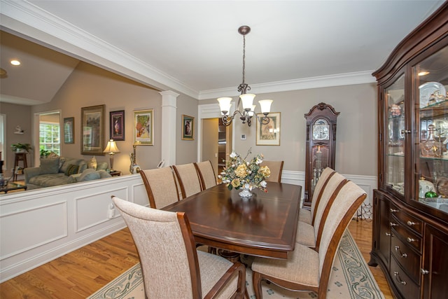 42 Kimberly Dr Unit 42, Westhampton, NY 11977 - dining space featuring light wood-style flooring, a chandelier, a wainscoted wall, and ornamental molding