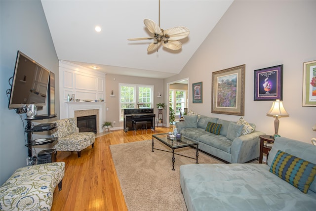 42 Kimberly Dr Unit 42, Westhampton, NY 11977 - living room featuring light wood-style floors, a ceiling fan, high vaulted ceiling, and a fireplace with flush hearth