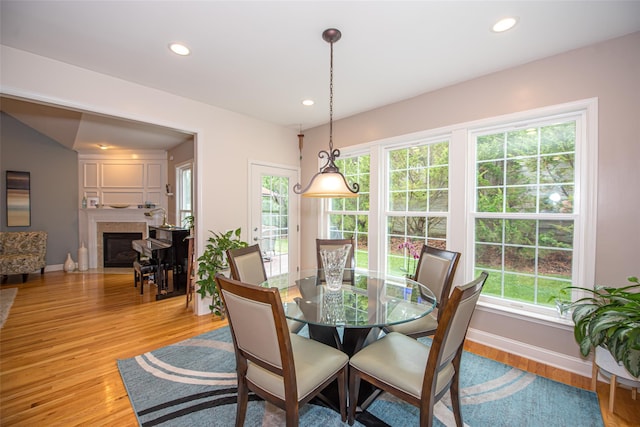 42 Kimberly Dr Unit 42, Westhampton, NY 11977 - dining space with a fireplace with flush hearth, baseboards, light wood finished floors, and recessed lighting