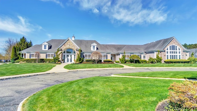 42 Kimberly Dr Unit 42, Westhampton, NY 11977 - view of front of house with french doors, stone siding, a front lawn, and a chimney