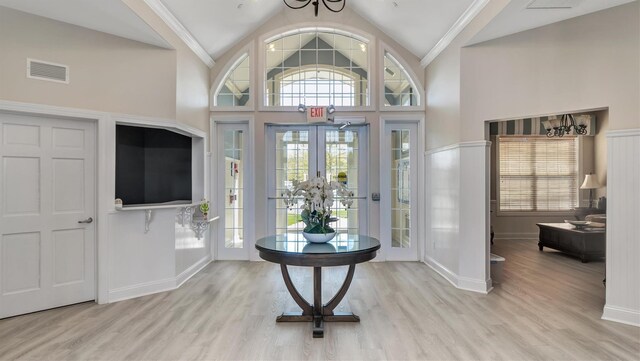 42 Kimberly Dr Unit 42, Westhampton, NY 11977 - foyer entrance with baseboards, wood finished floors, and high vaulted ceiling