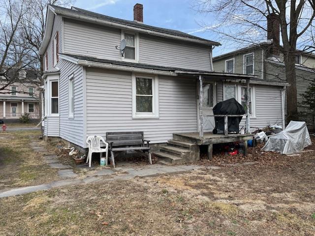 rear view of property with a chimney