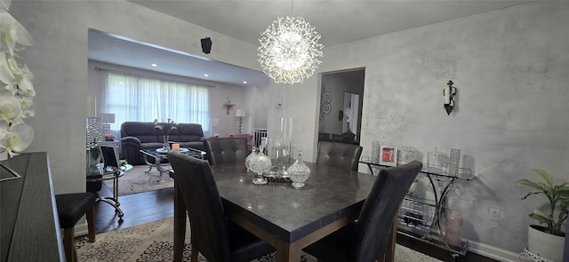dining space featuring a chandelier and wood finished floors