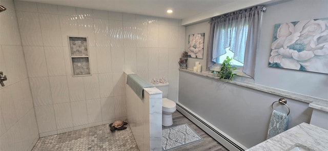 full bath with a baseboard heating unit, walk in shower, toilet, wood finished floors, and recessed lighting