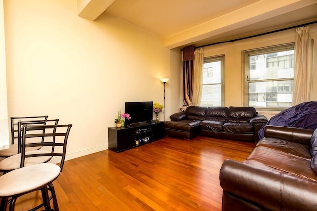 living area with wood finished floors and baseboards