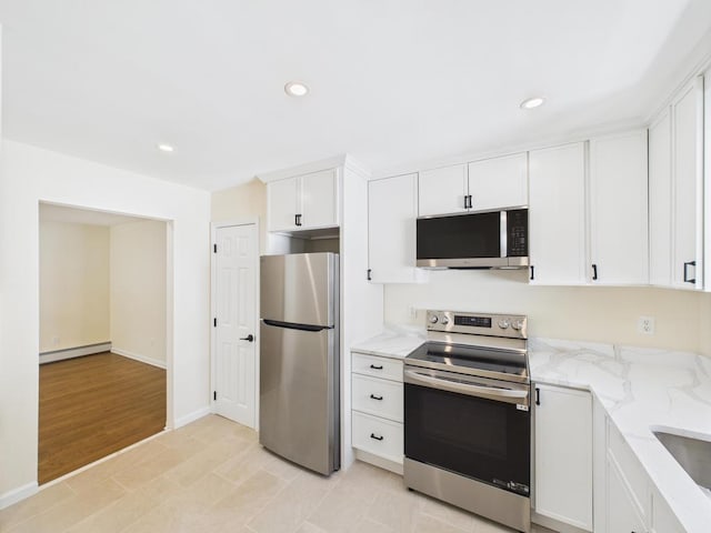 kitchen featuring stainless steel appliances, white cabinets, baseboard heating, light stone counters, and recessed lighting