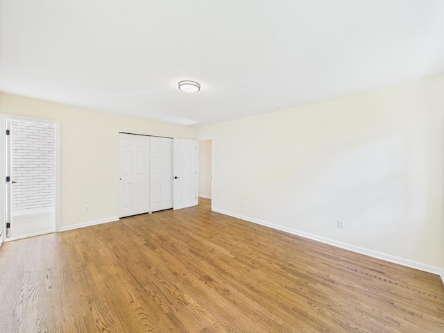 unfurnished bedroom with baseboards and light wood-style floors