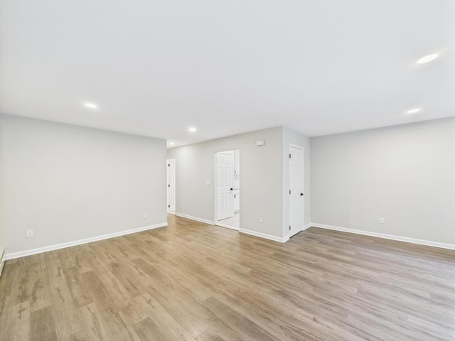 below grade area with light wood-style floors, baseboards, and recessed lighting