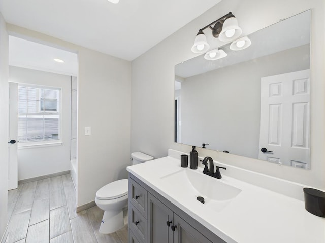 full bathroom with toilet, vanity, baseboards, shower / bath combination, and recessed lighting