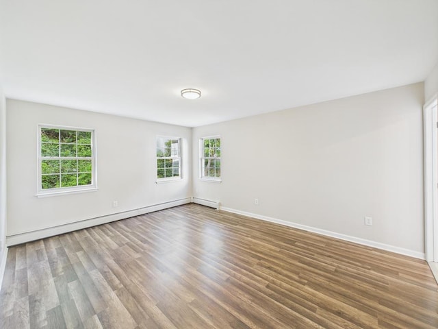 unfurnished room with wood finished floors and baseboards