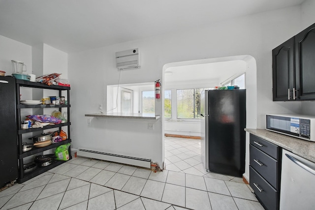 5404 State Route 55, Liberty, NY 12754 - kitchen with freestanding refrigerator, a baseboard heating unit, light countertops, light tile patterned floors, and dark cabinets