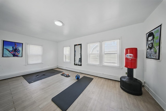 5404 State Route 55, Liberty, NY 12754 - exercise room featuring a baseboard radiator, baseboards, and wood finished floors
