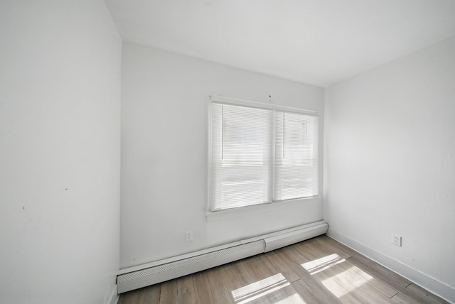 5404 State Route 55, Liberty, NY 12754 - unfurnished room featuring baseboard heating, wood finished floors, and baseboards