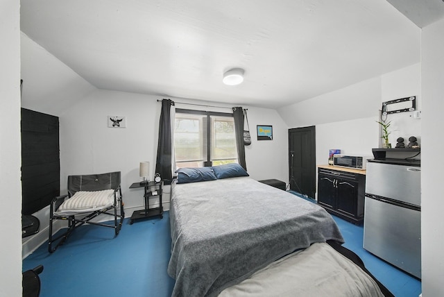 5404 State Route 55, Liberty, NY 12754 - bedroom featuring freestanding refrigerator, vaulted ceiling, and concrete flooring