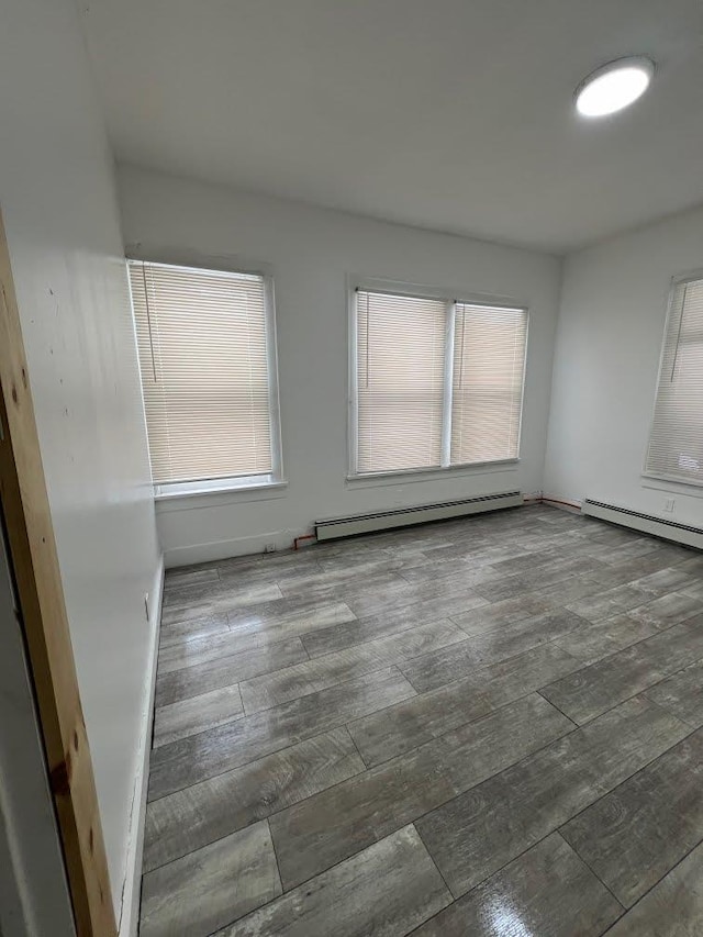 5404 State Route 55, Liberty, NY 12754 - spare room with baseboard heating, hardwood / wood-style floors, and plenty of natural light