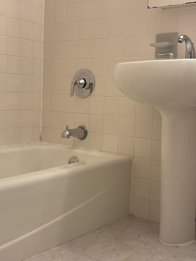 full bath featuring a tub and tile walls